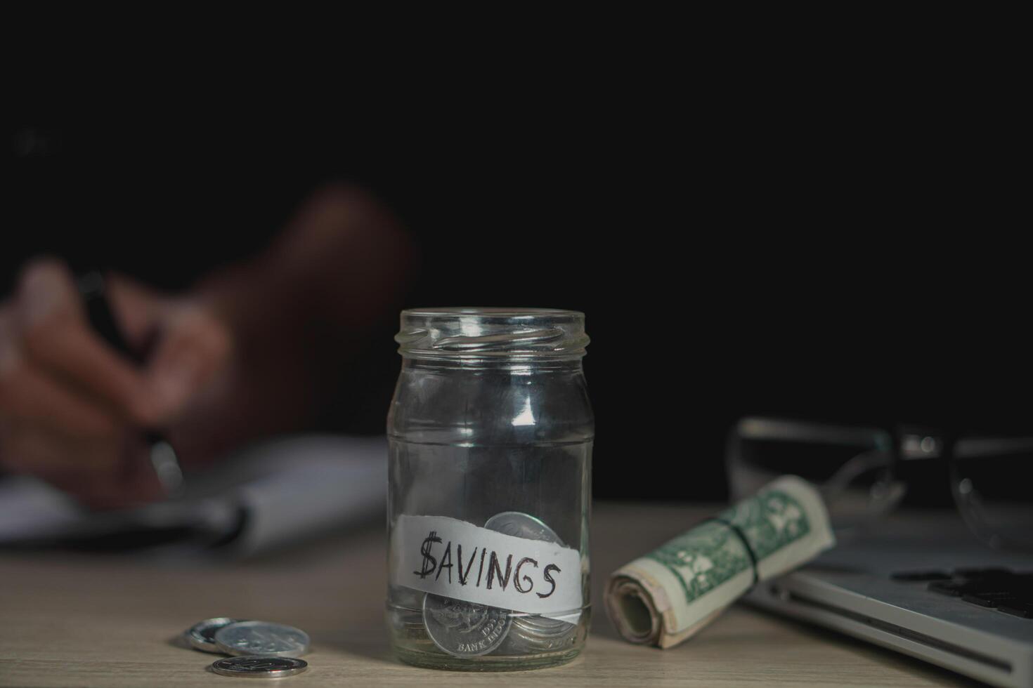 money saving business On a table in dark room. Money Saving Ideas for Financial Accounting photo