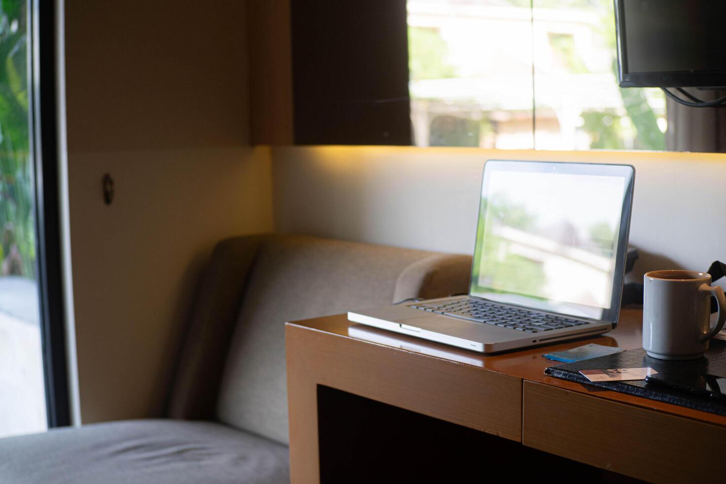 Cozy workspace with laptop and coffee photo