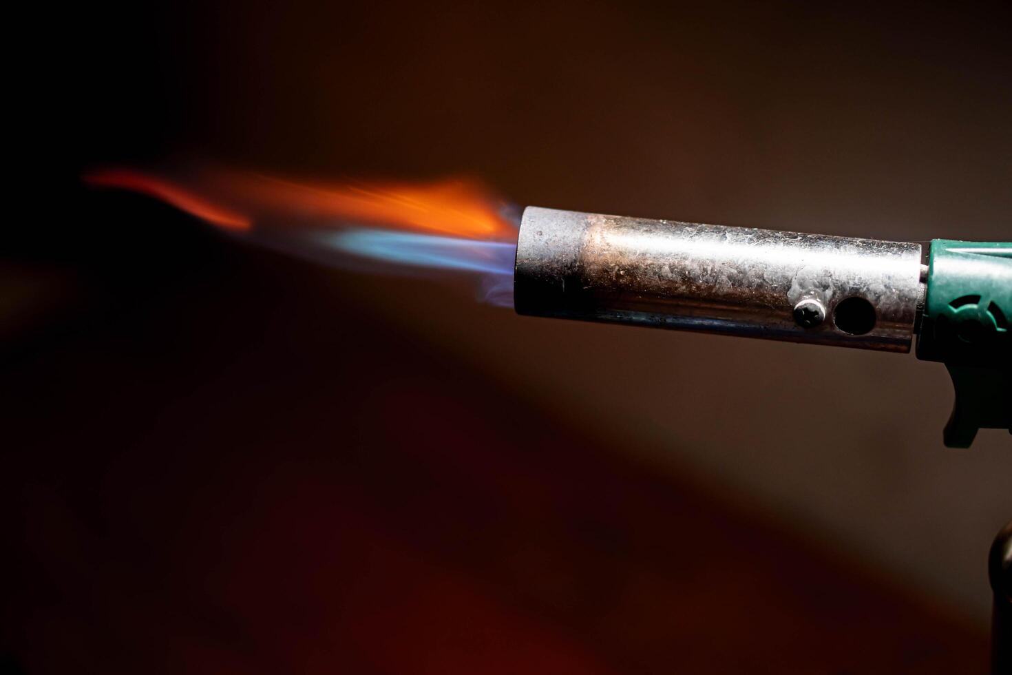 Blowtorch with blue and orange flame photo