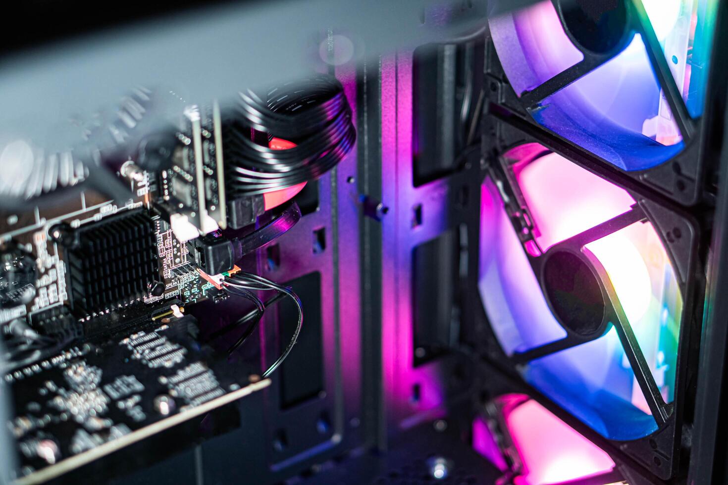 Computer case interior with RGB lighting and cooling fans photo
