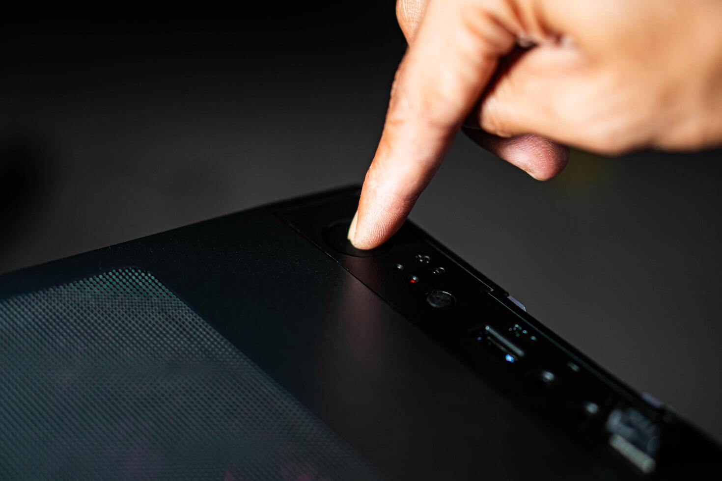 Pressing power button on computer case photo