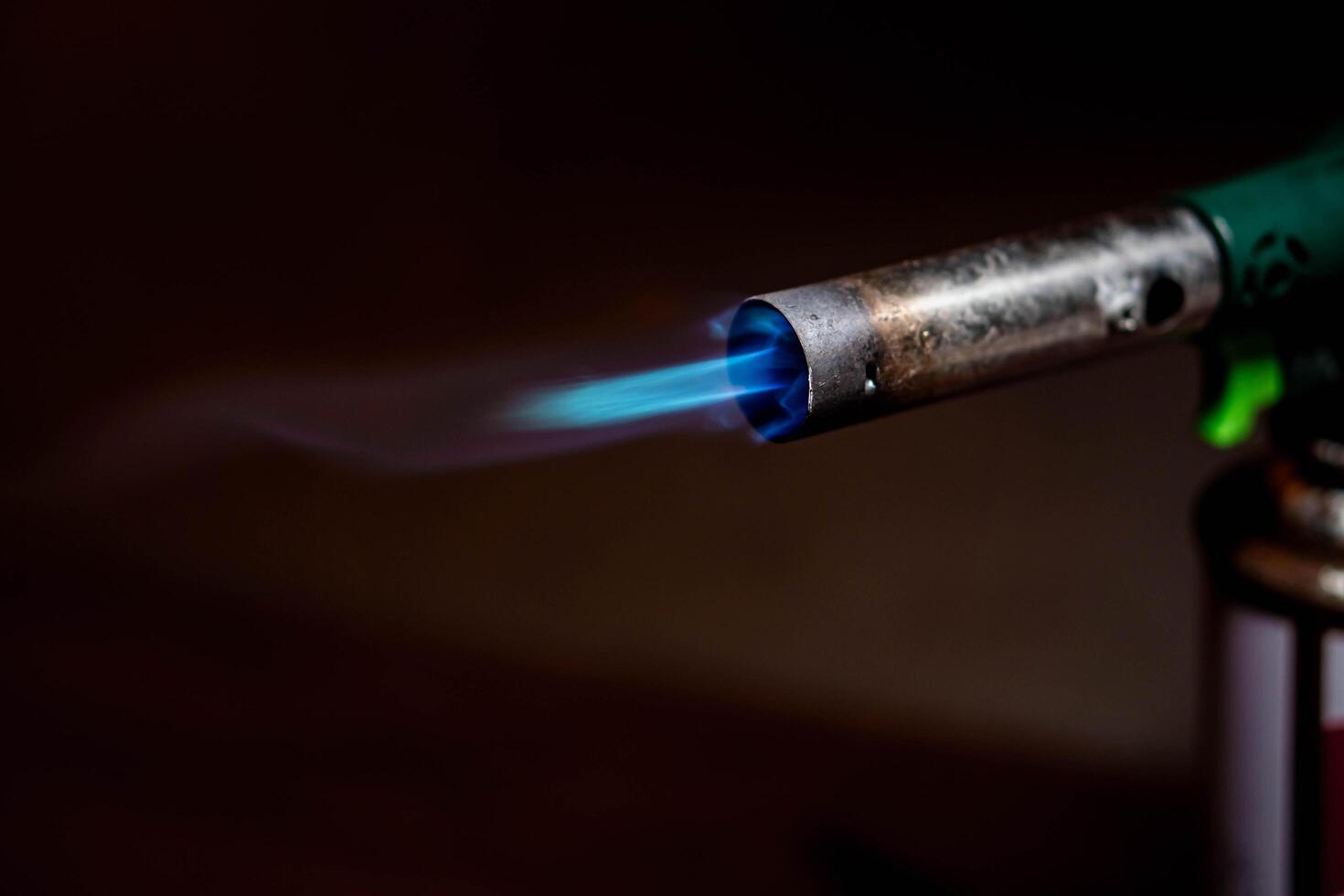 Lit blowtorch with blue flame photo