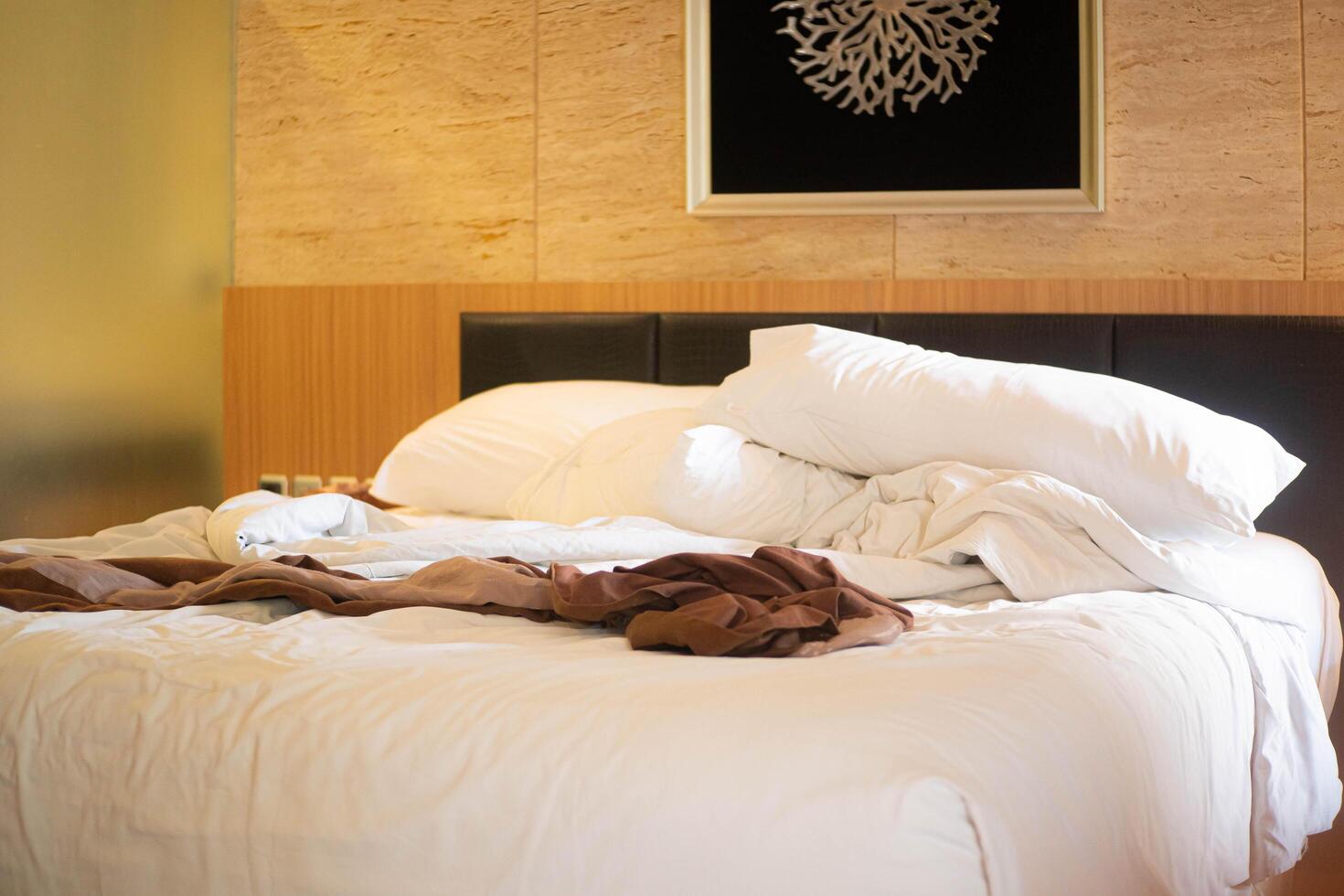 Unmade Bed with Contemporary Ar photo