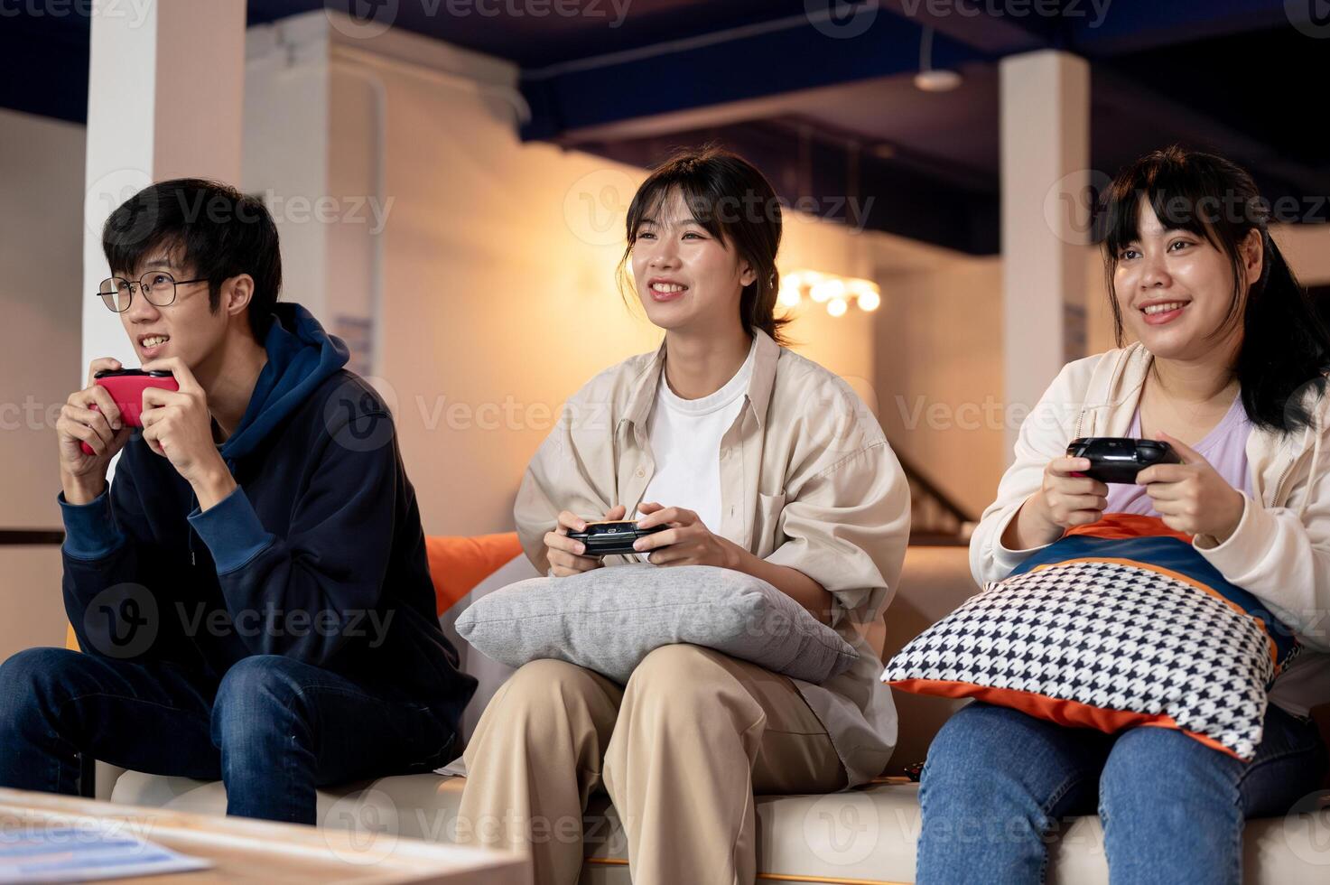 A group of young, cheerful Asian friends is enjoying playing a game together at home. photo