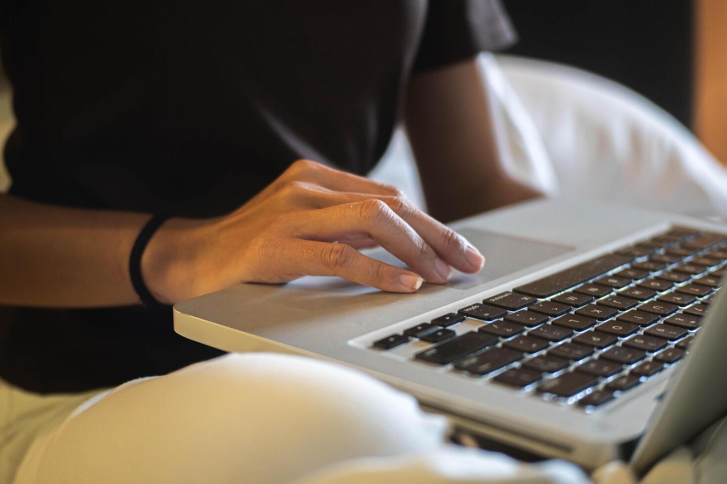 Person using laptop on lap photo