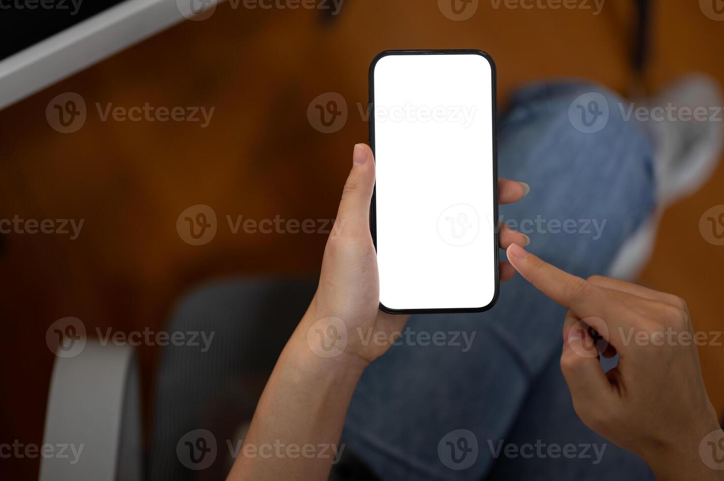 Top view image of a woman using her smartphone in the office. A white-screen smartphone mockup. photo