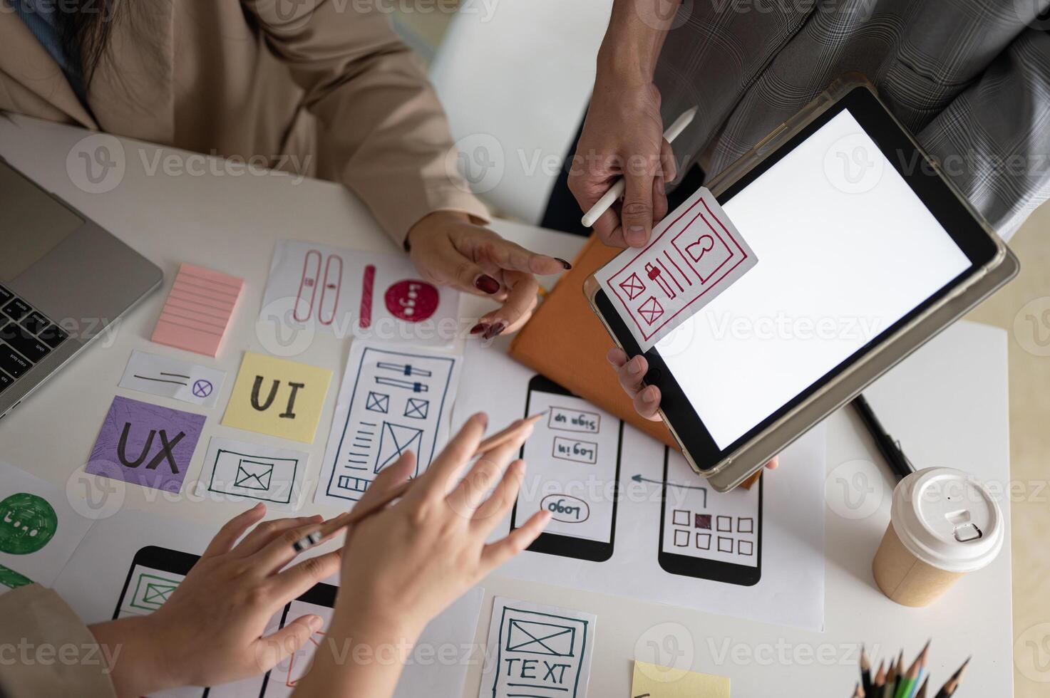 Close-up image of a graphic designer team is in the meeting, looking at a digital tablet screen. photo