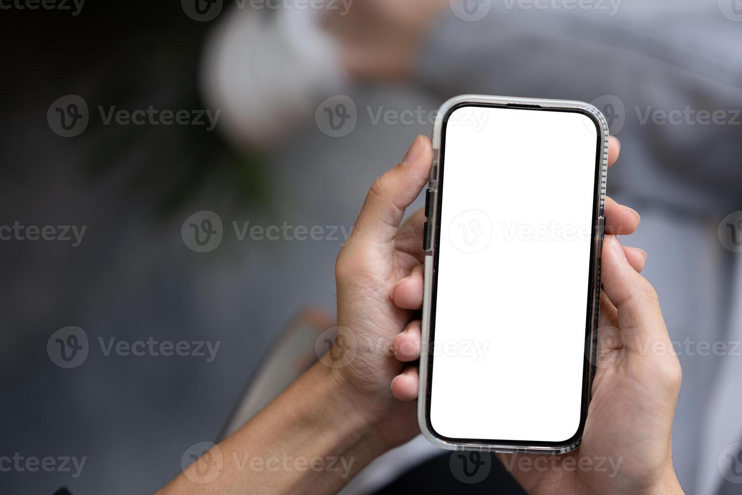 Close-up image of a man using his smartphone outdoors. A white-screen smartphone mockup. photo