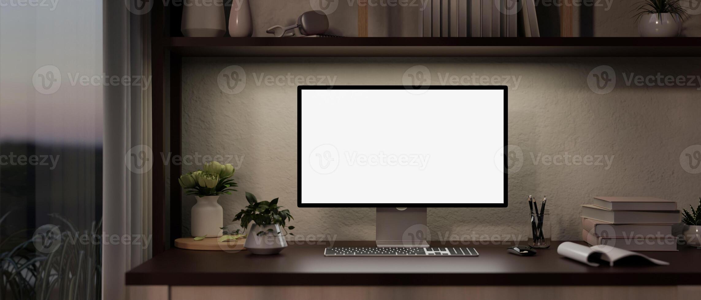 A computer mockup and office supplies on a desk in a modern office room in the evening. photo