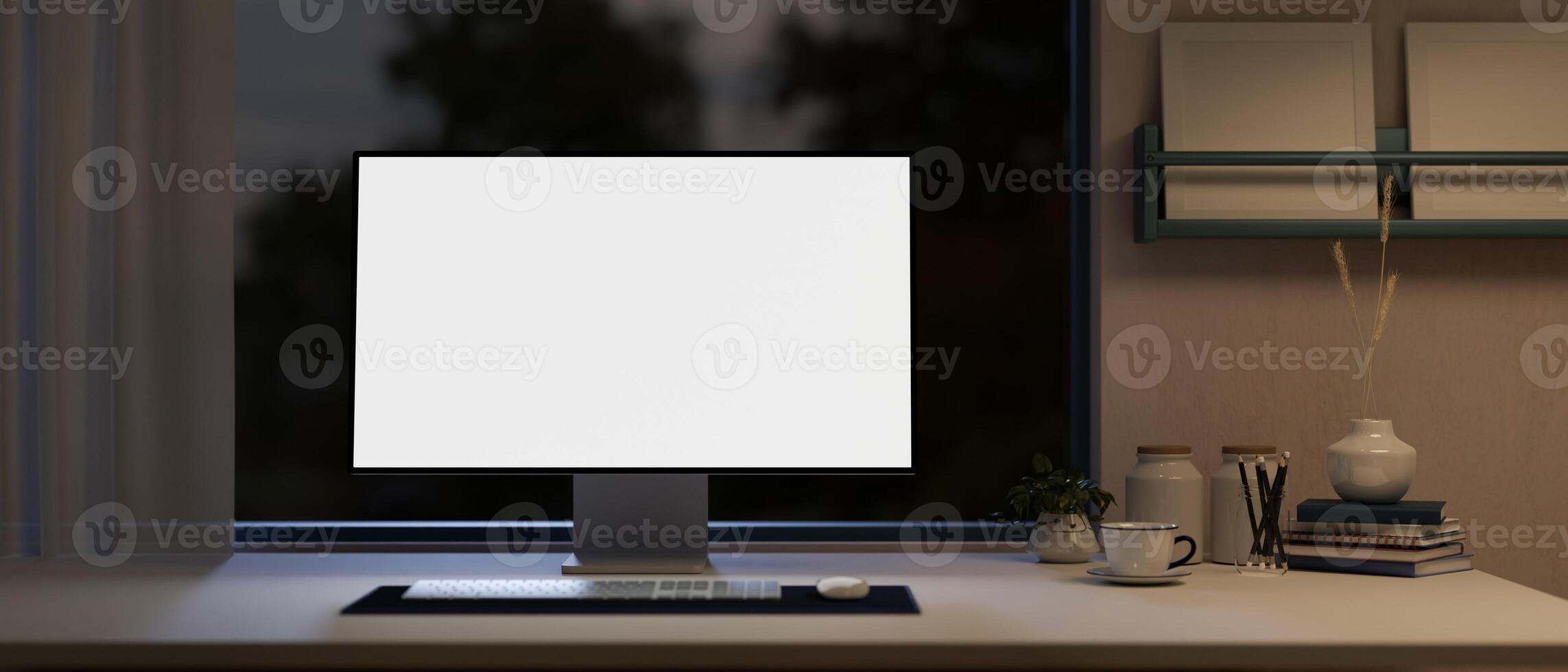 Front view of a white-screen computer mockup on a table in a modern home office at night. photo