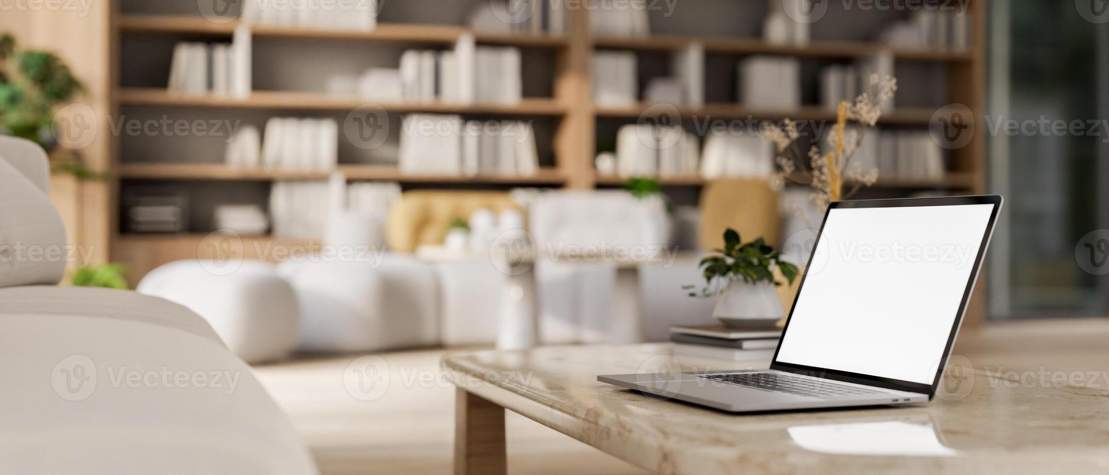 A laptop computer on a neutral marble coffee table in a contemporary, spacious living room. photo