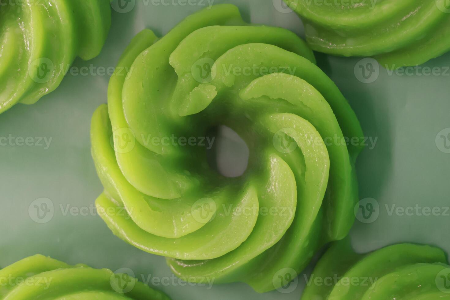 This legendary dessert is a popular Malaysian treat that combines wheat flour, tapioca starch, and screwpine extract, steamed and coated with coconut shreds, served homemade, or sold at street stalls. photo