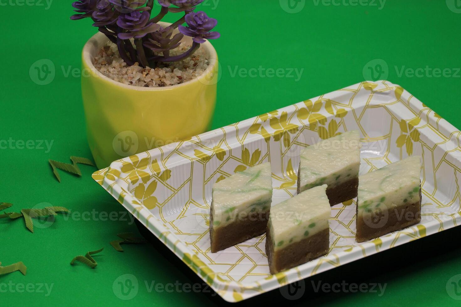 Relish the Malaysian legendary treat, made with pandan-flavored green rice flour jelly, coconut milk, and palm sugar syrup, steamed, and served, available both homemade and at street stalls. photo