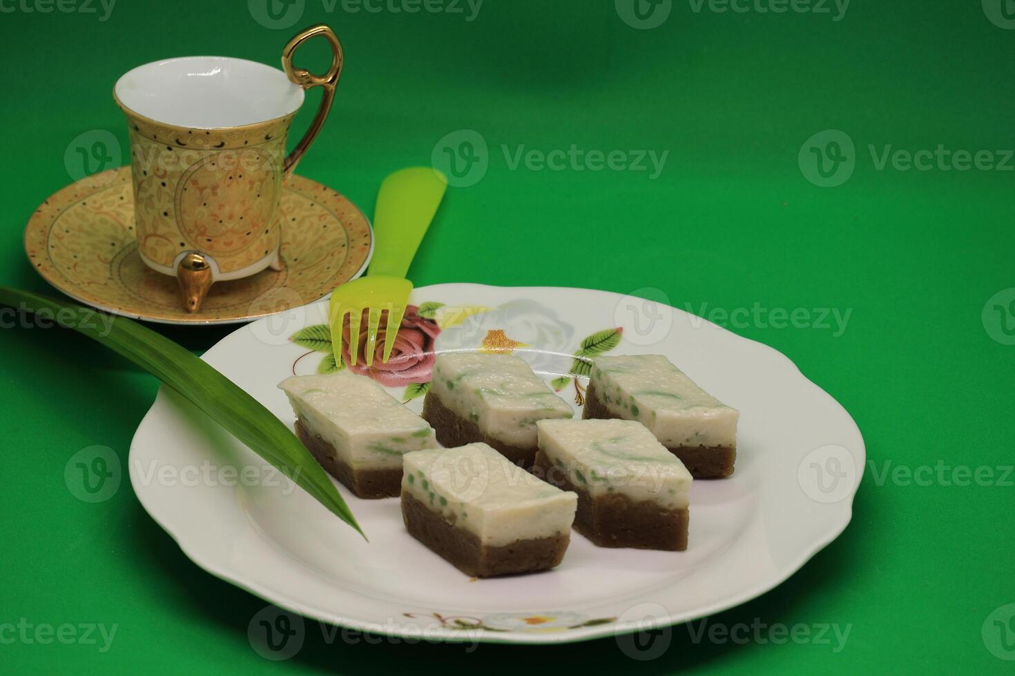 Relish the Malaysian legendary treat, made with pandan-flavored green rice flour jelly, coconut milk, and palm sugar syrup, steamed, and served, available both homemade and at street stalls. photo