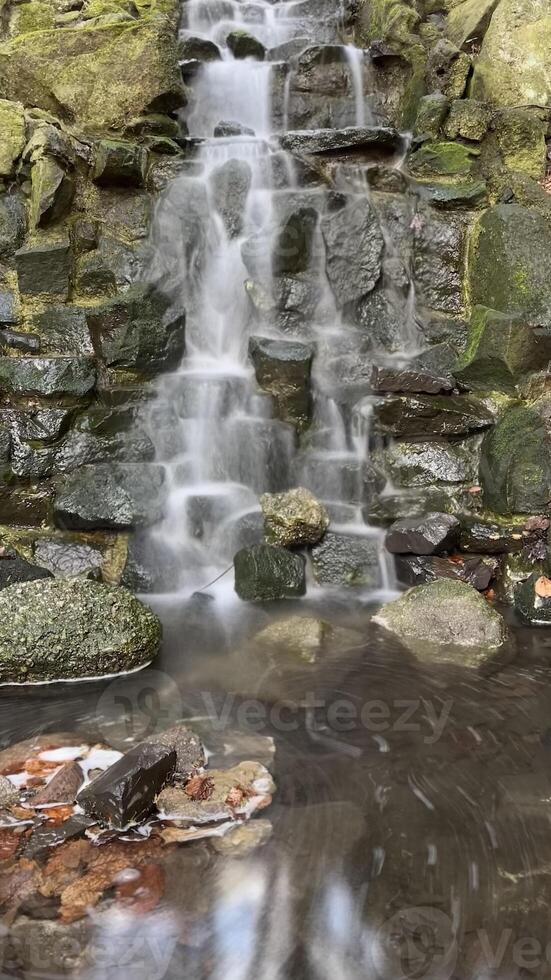 Small waterfall with flowing water in Poland, long exposure photo
