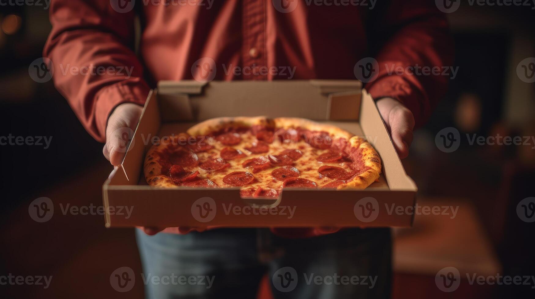 Hands holding a pizza box. Pizza is ready for delivery. . photo