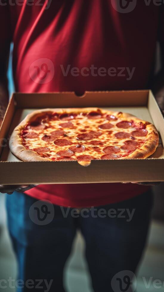 Hands holding a pizza box. Pizza is ready for delivery. . photo