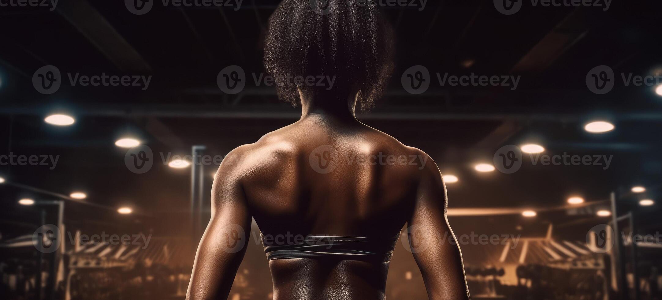 African american woman working out in gym on gym background, copy space for text or design. . photo
