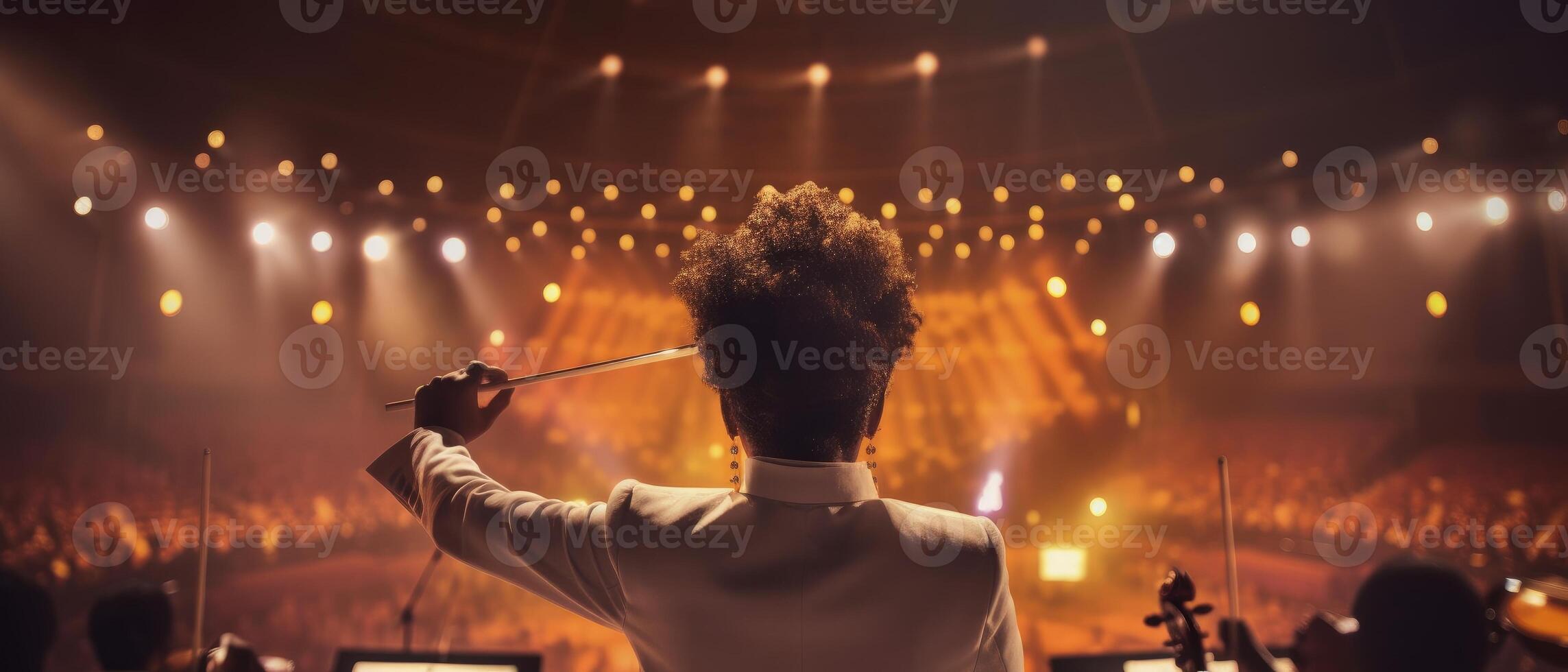 A young woman confidently leads an orchestra with a baton. Concept of musical talent. . photo