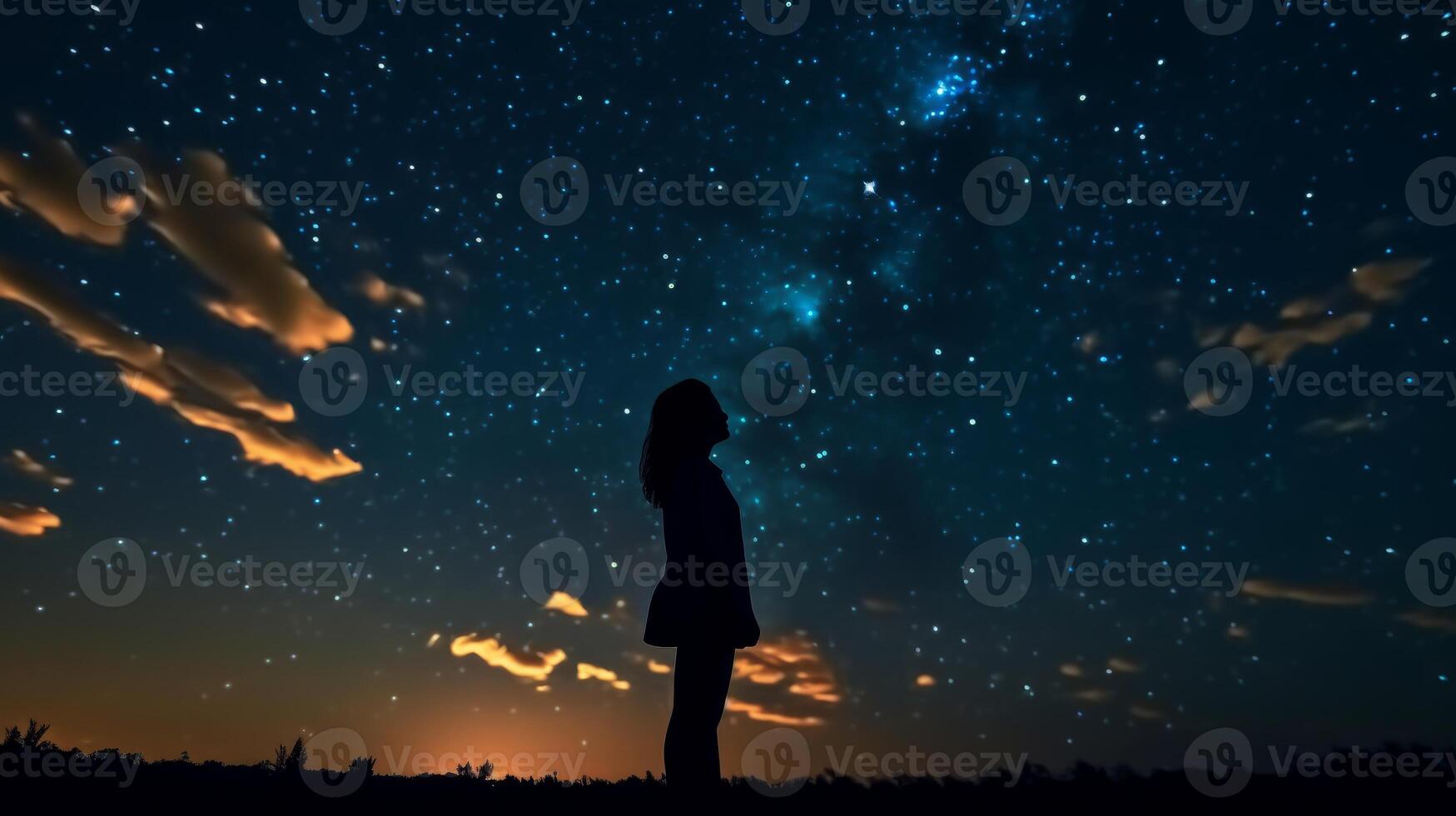 Silhouette of a girl looks at the starry sky. . photo