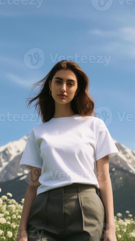 A beautiful girl in a white T-shirt against the background of a beautiful landscape. photo