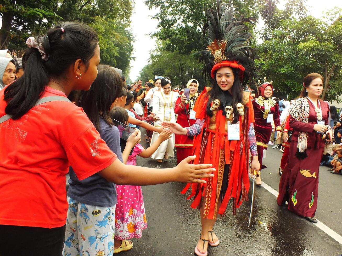 Surakarta City, Central Java, Indonesia, May 15, 2024. Tourist attraction on a traditional costume parade at Slamet Riyadi Street. photo