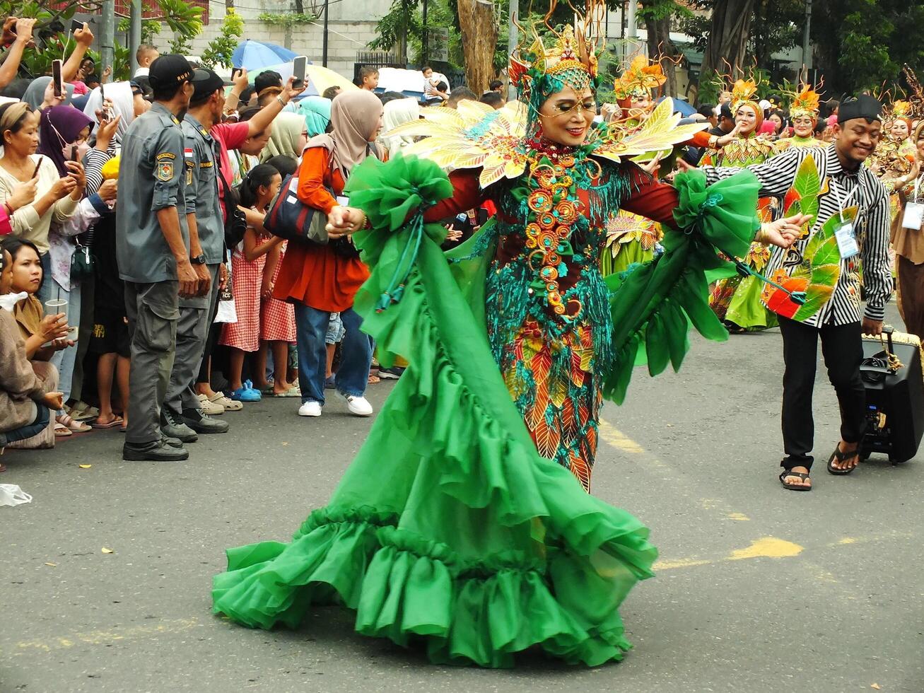 Surakarta City, Central Java, Indonesia, May 15, 2024. Tourist attraction on a traditional costume parade at Slamet Riyadi Street. photo