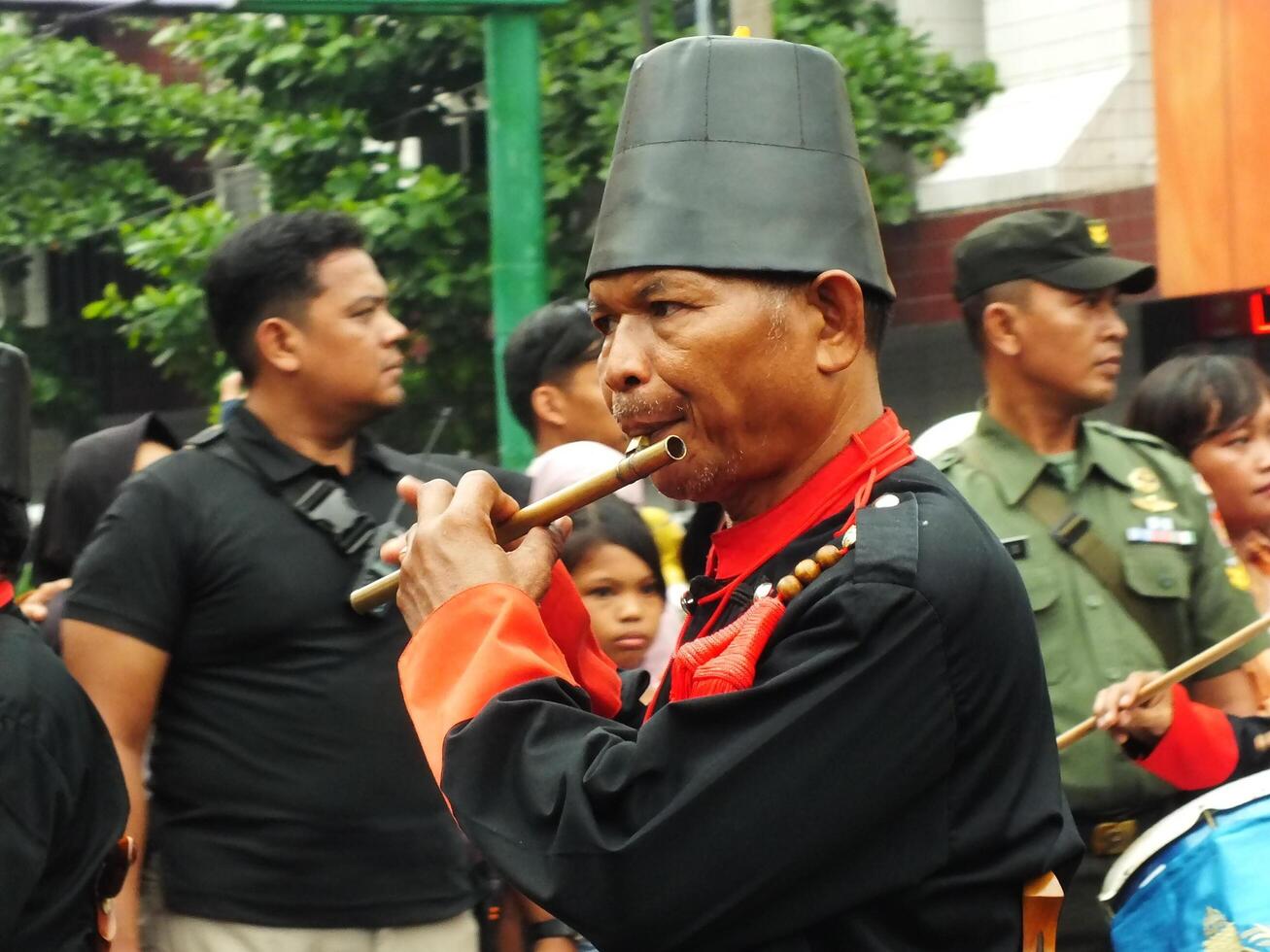 Surakarta City, Central Java, Indonesia, May 15, 2024. Tourist attraction on a traditional costume parade at Slamet Riyadi Street. photo