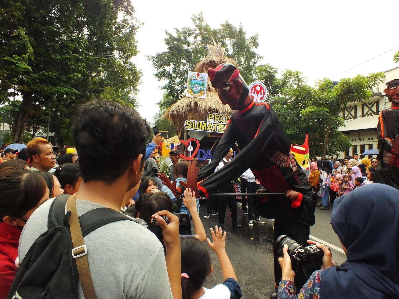 Surakarta City, Central Java, Indonesia, May 15, 2024. Tourist attraction on a traditional costume parade at Slamet Riyadi Street. photo