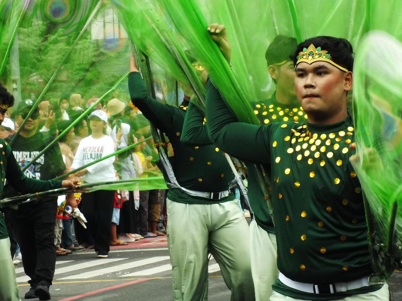 Surakarta City, Central Java, Indonesia, May 15, 2024. Tourist attraction on a traditional costume parade at Slamet Riyadi Street. photo