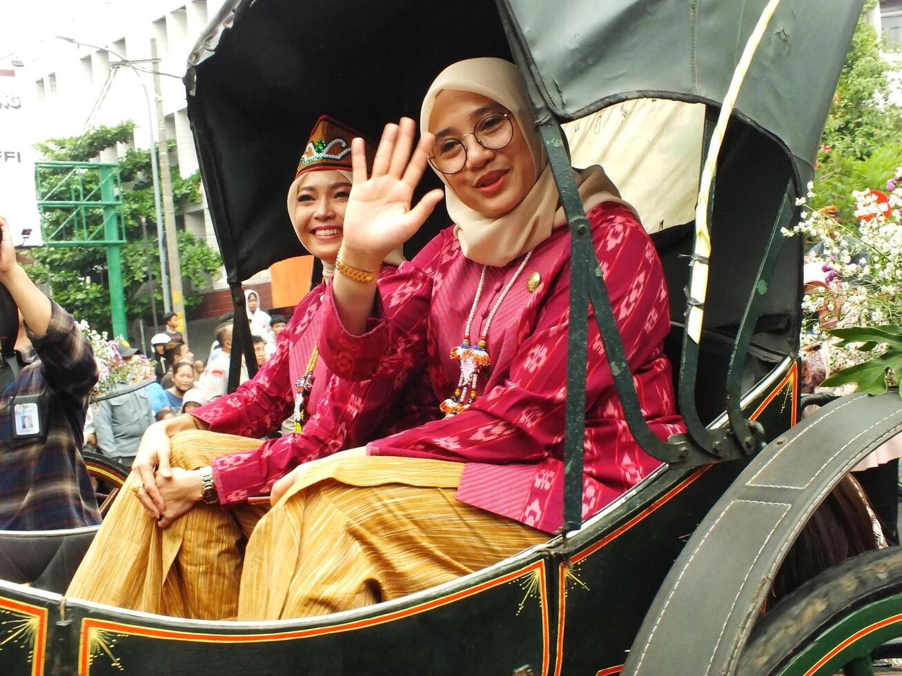 Surakarta City, Central Java, Indonesia, May 15, 2024. Tourist attraction on a traditional costume parade at Slamet Riyadi Street. photo