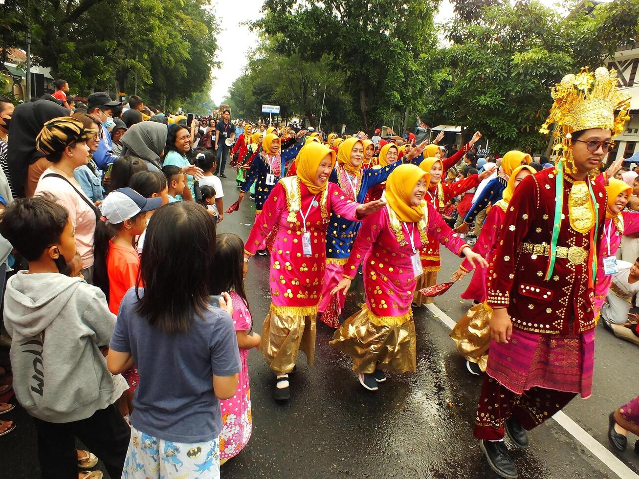 Surakarta City, Central Java, Indonesia, May 15, 2024. Tourist attraction on a traditional costume parade at Slamet Riyadi Street. photo