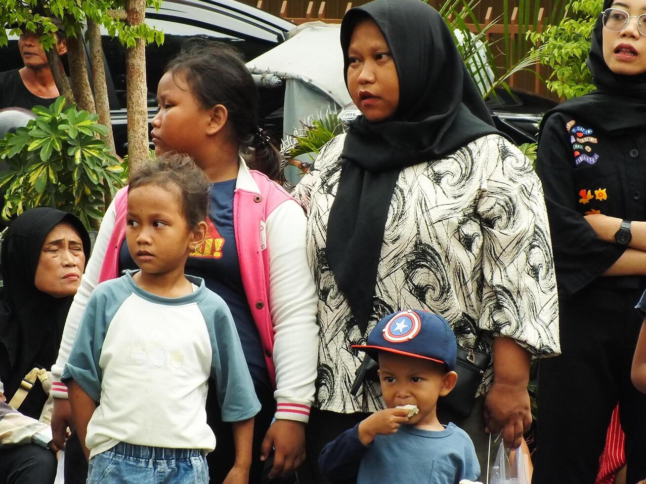 Surakarta City, Central Java, Indonesia, May 15, 2024. Crowd people watching a parade at Slamet Riyadi Street. photo