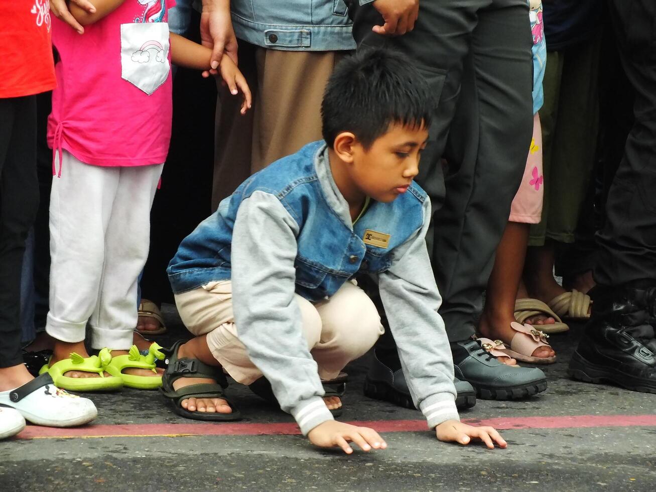 Surakarta City, Central Java, Indonesia, May 15, 2024. Crowd people watching a parade at Slamet Riyadi Street. photo