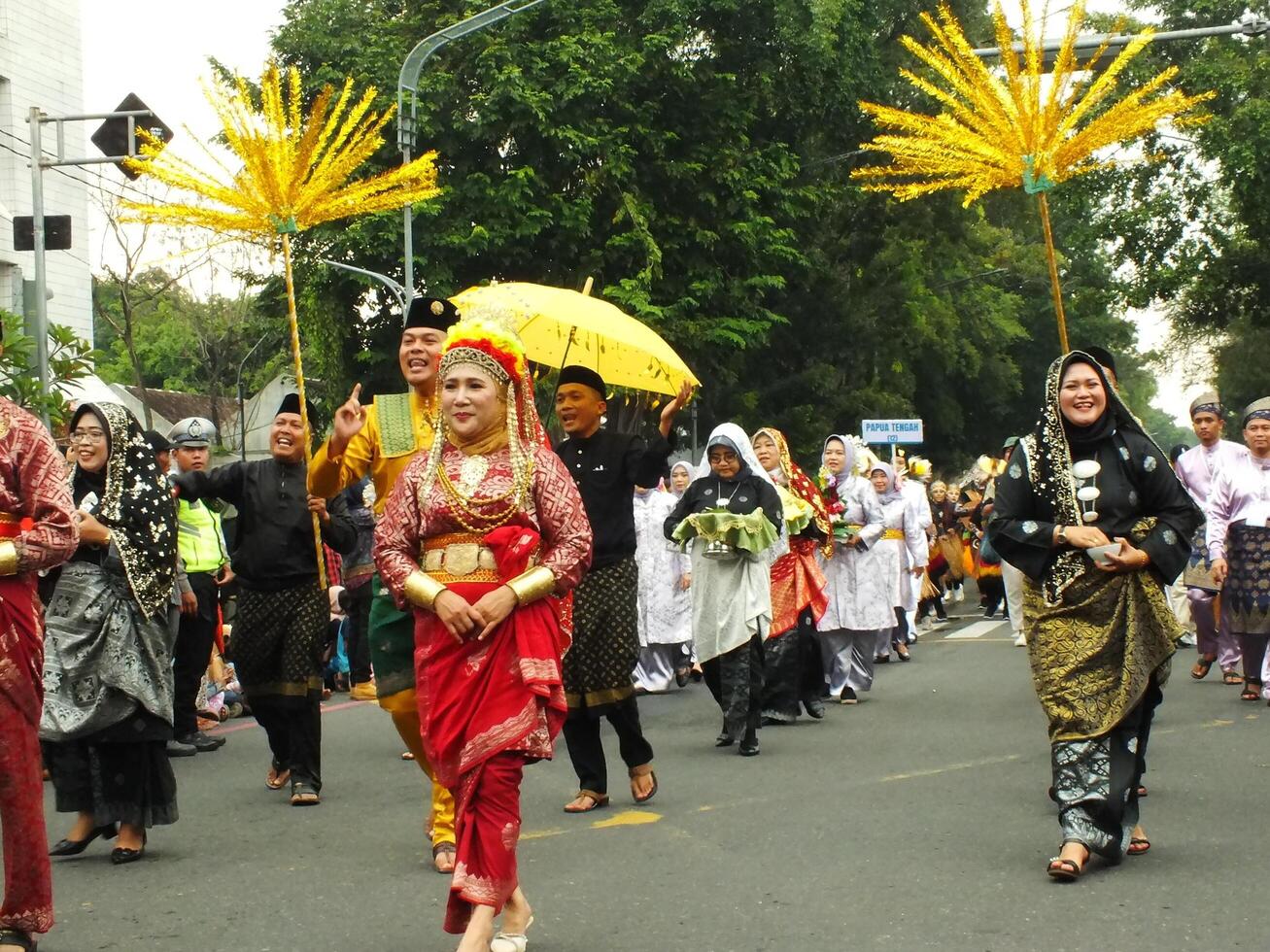Surakarta City, Central Java, Indonesia, May 15, 2024. Tourist attraction on a traditional costume parade at Slamet Riyadi Street. photo