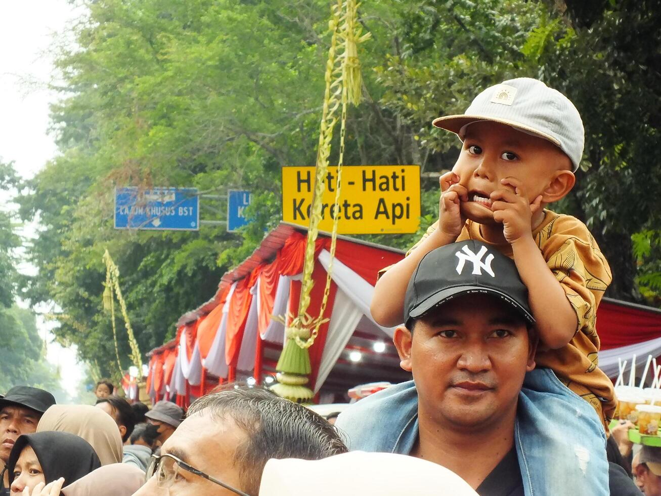 Surakarta City, Central Java, Indonesia, May 15, 2024. Crowd people watching a parade at Slamet Riyadi Street. photo