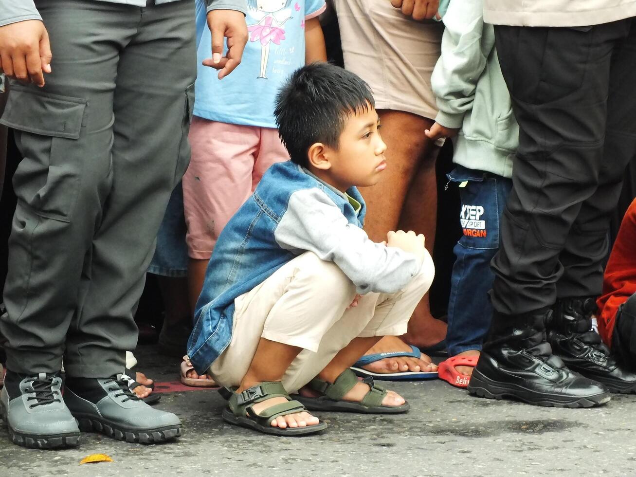 Surakarta City, Central Java, Indonesia, May 15, 2024. Crowd people watching a parade at Slamet Riyadi Street. photo