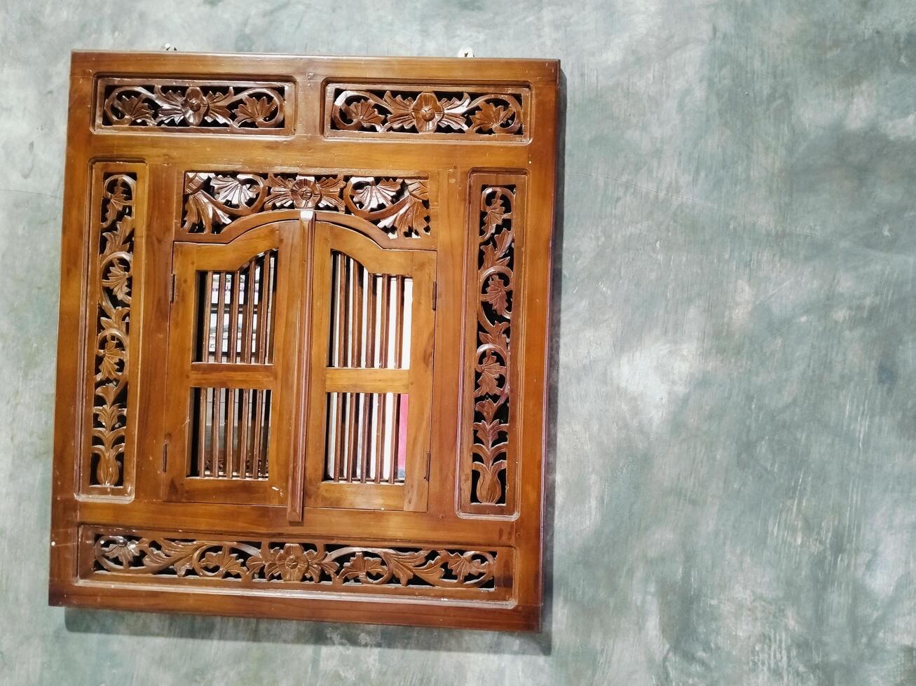 Carved wooden Krepyak frame, window mirror wall decoration, typical Indonesian photo