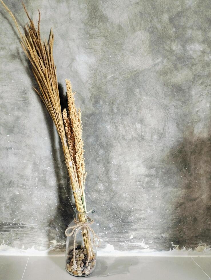 Dried flowers in the vase, Beautiful dried flower arrangement in a stylish glass vase, Still life of a bouquet of dried flowers in a glass bottle photo