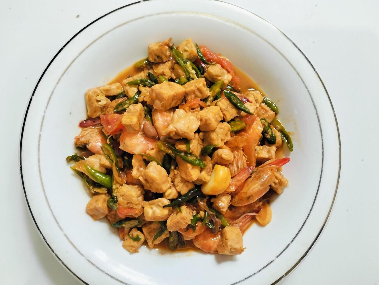 Stir-fry tempeh shrimp, focus of Spicy tempeh cooked in Indonesian styles. Stir fried slicy tempeh,seasoning with shrimp paste with chilies photo