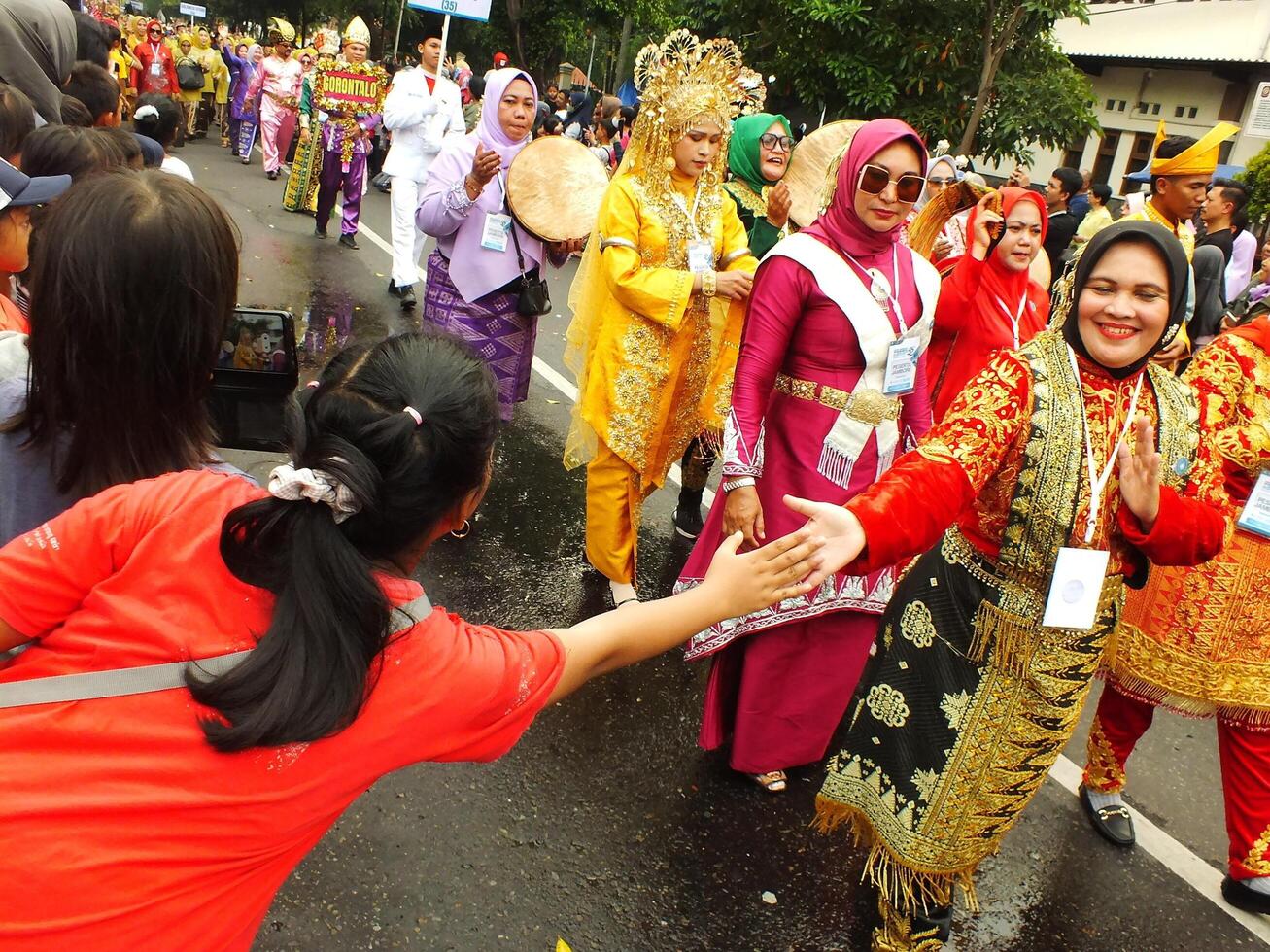 Surakarta City, Central Java, Indonesia, May 15, 2024. Tourist attraction on a traditional costume parade at Slamet Riyadi Street. photo