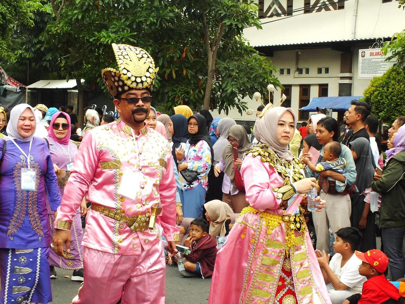 Surakarta City, Central Java, Indonesia, May 15, 2024. Tourist attraction on a traditional costume parade at Slamet Riyadi Street. photo