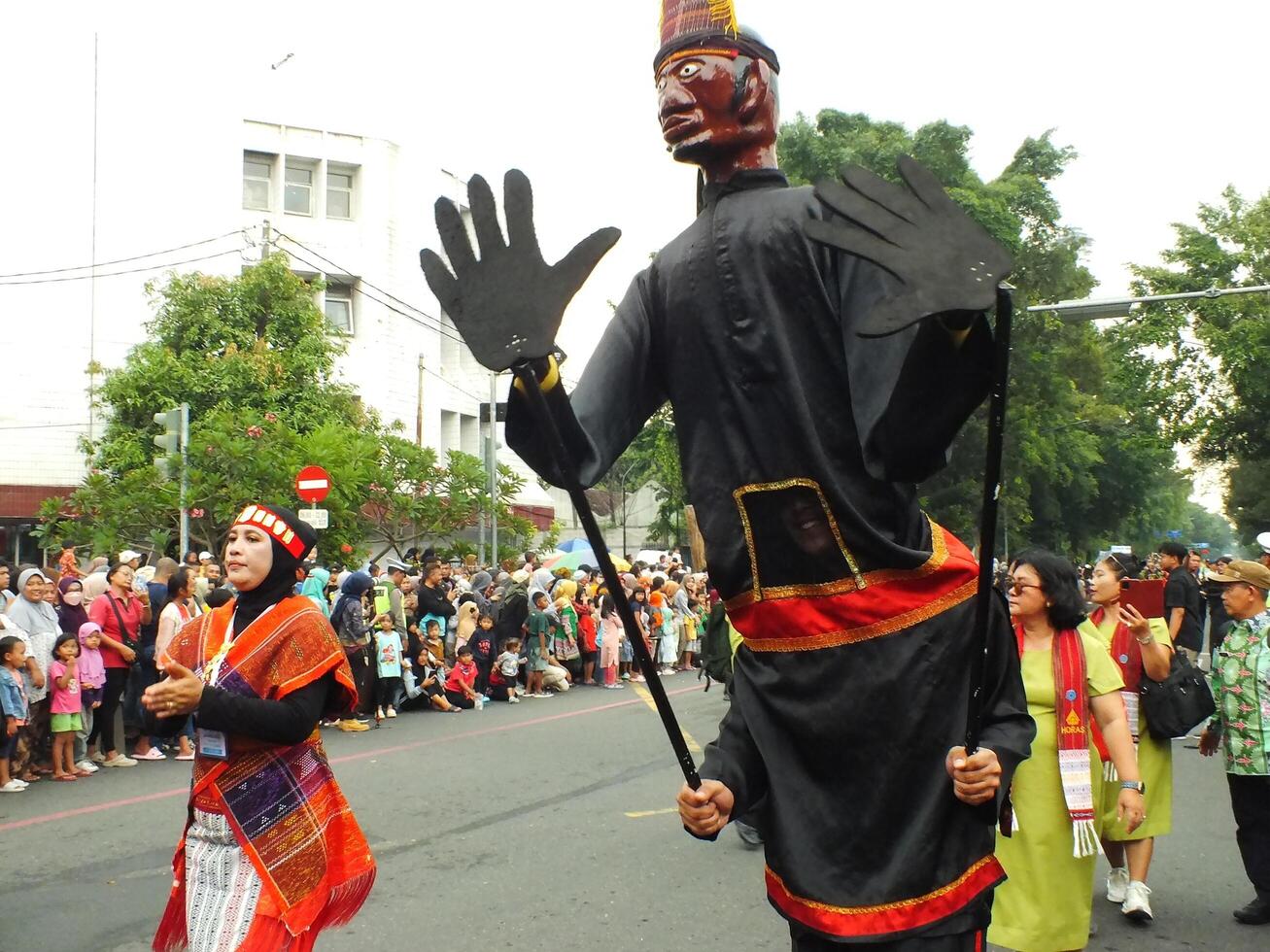 Surakarta City, Central Java, Indonesia, May 15, 2024. Tourist attraction on a traditional costume parade at Slamet Riyadi Street. photo
