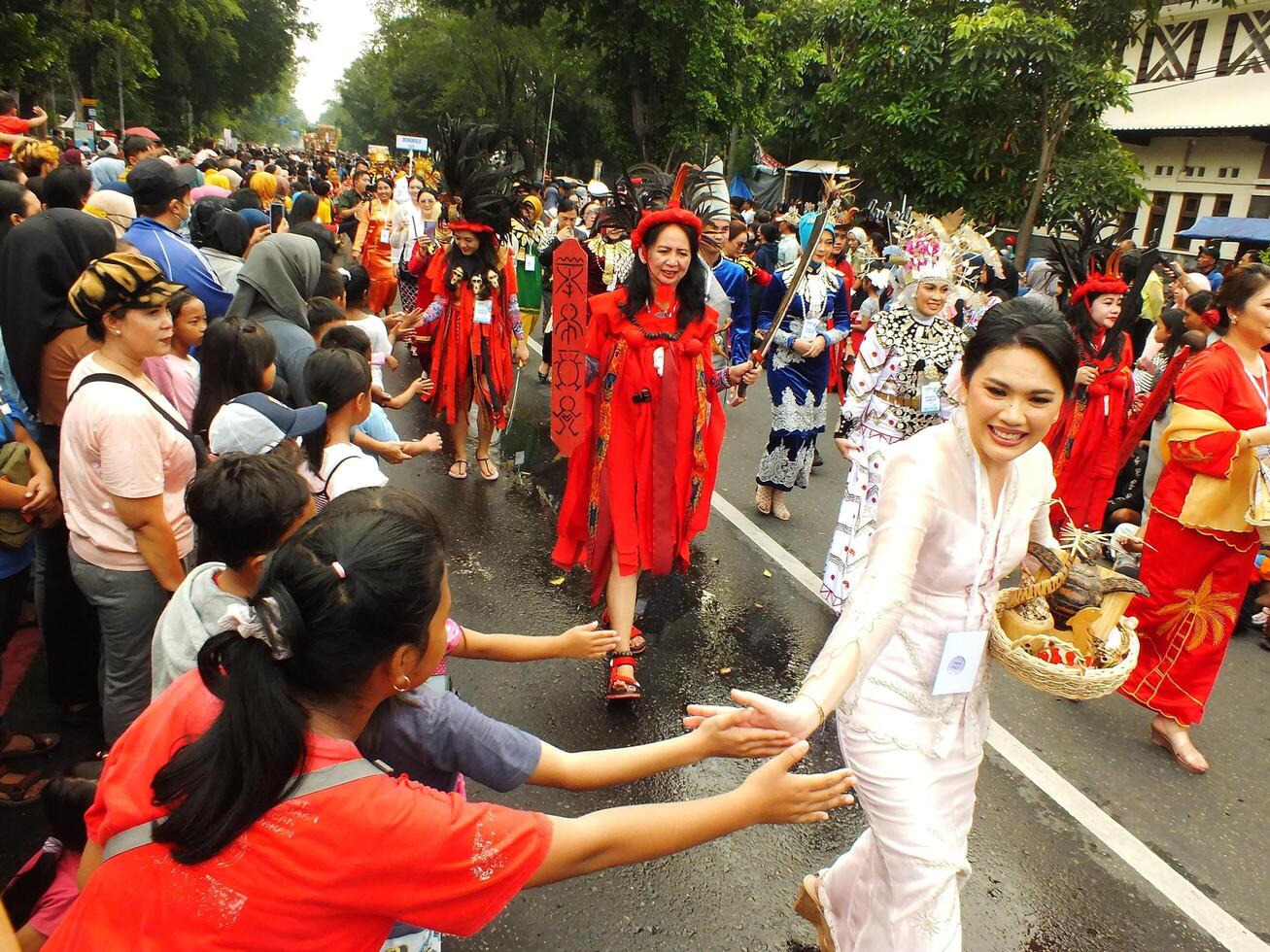 Surakarta City, Central Java, Indonesia, May 15, 2024. Tourist attraction on a traditional costume parade at Slamet Riyadi Street. photo