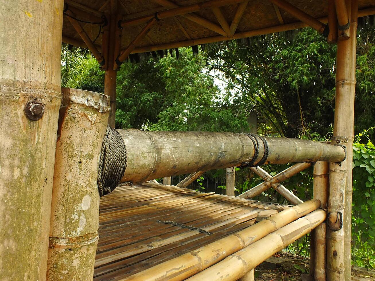 Traditional Bamboo Gazebo in shade under the trees. a relaxing place to unwind photo