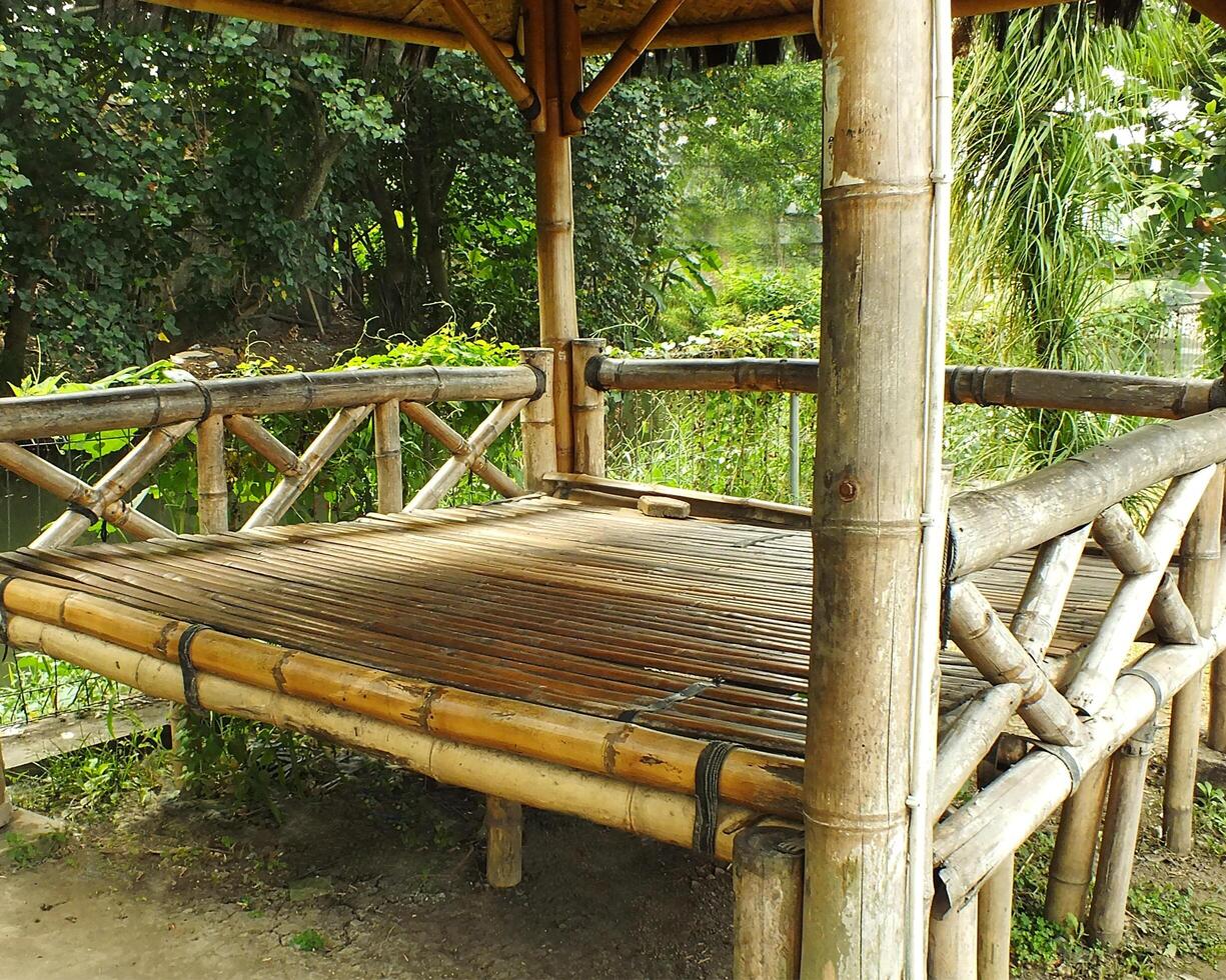 Traditional Bamboo Gazebo in shade under the trees. a relaxing place to unwind photo