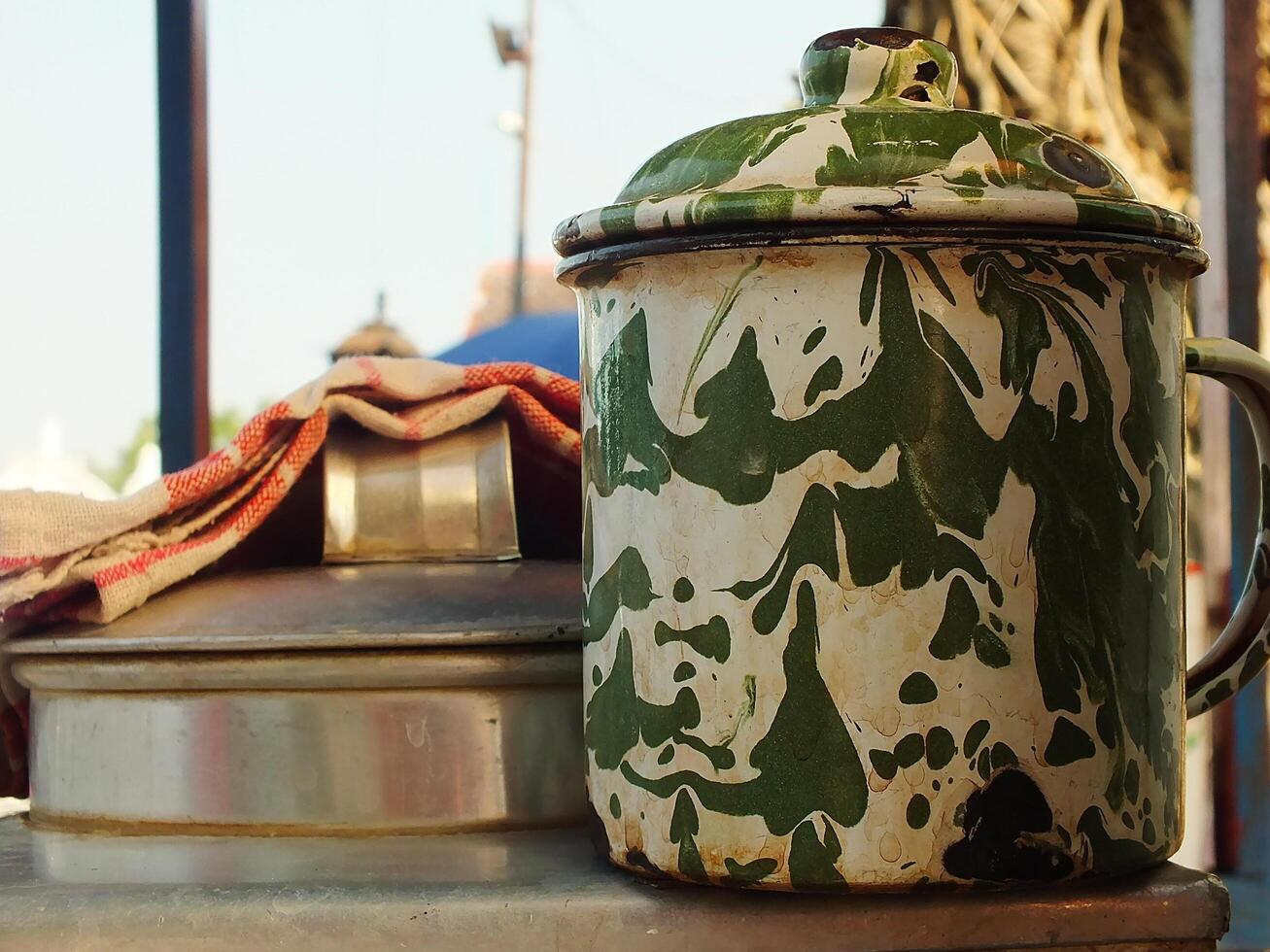 An unique enamel mug with blirik pattern commonly found at java. Used for everyday needs for drink coffee or tea. photo