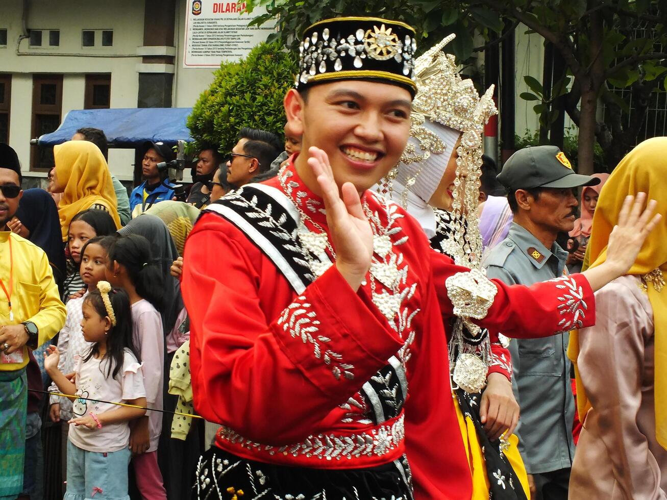 Surakarta City, Central Java, Indonesia, May 15, 2024. Tourist attraction on a traditional costume parade at Slamet Riyadi Street. photo