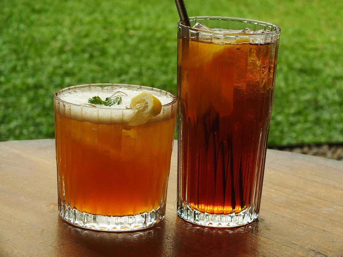 Cold brew fresh iced tea with lemon on wooden table. Refreshing drink on a hot summer day. Cafe image concept design background photo