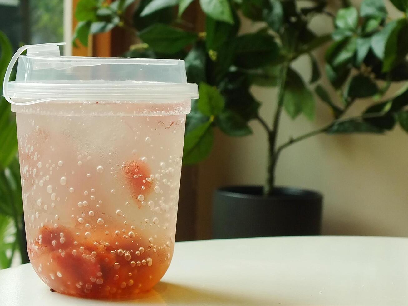 fresh and cold strawberry soda with ice isolated on blurred interior cafe shop. fresh drink for summer day. Food and beverage image for coffee shop and restaurant business photo